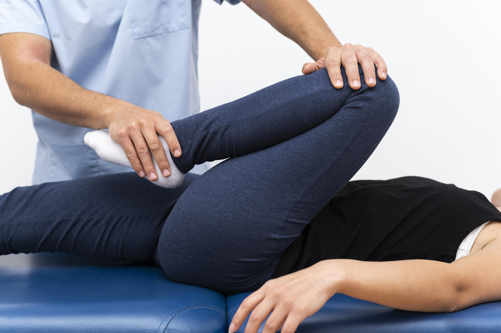 physiotherapist-doing-exercises-with-female-patient