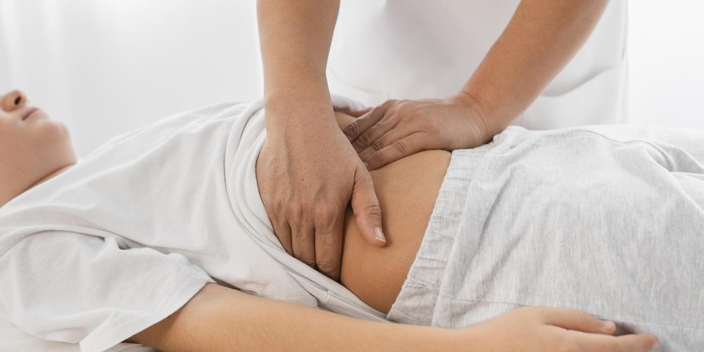 osteopathist-treating-kid-by-massaging-his-tummy.jpg